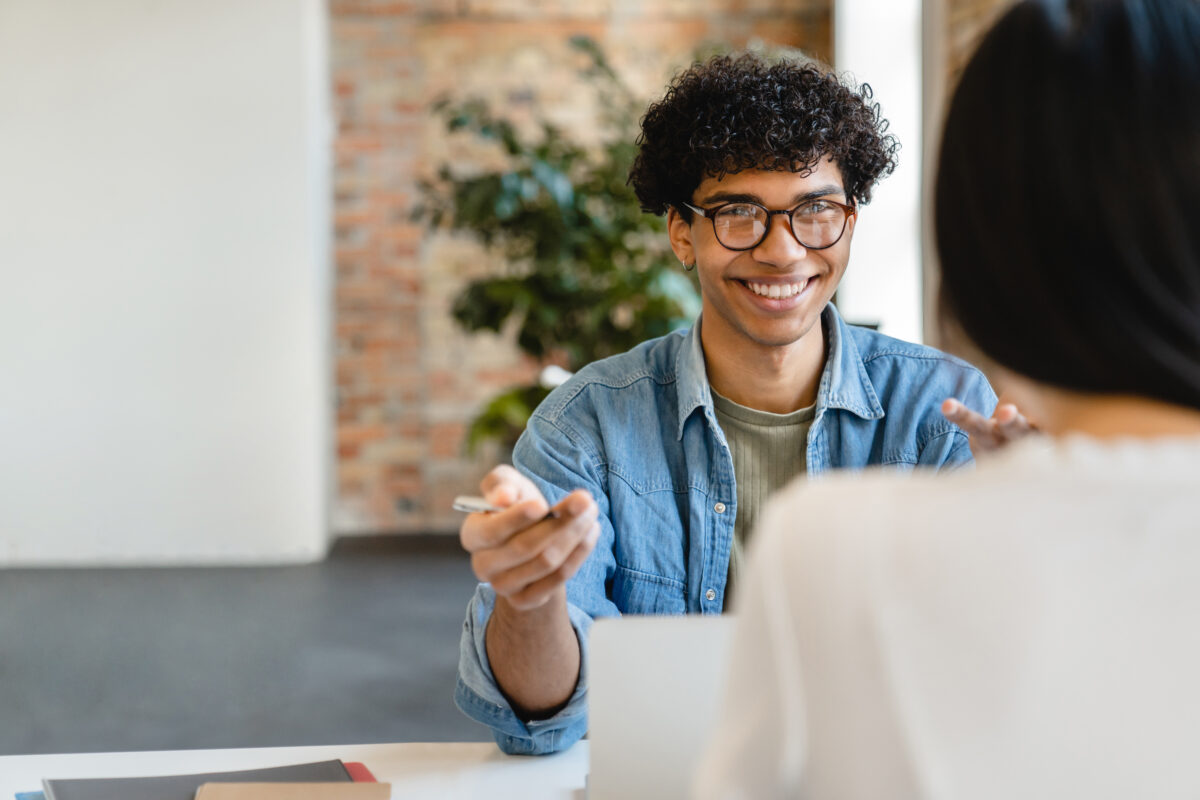 Successful young colleagues communicating on hiring manager and recruiter roles in their hiring process.